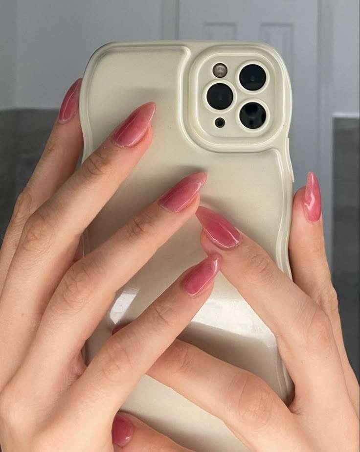 Sheer pastel-pink press-on nails with a jelly-like glossy finish, illustrating the translucent “jelly” mani trend