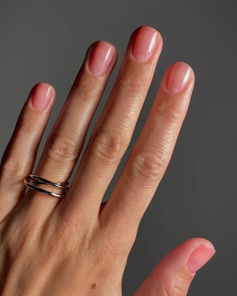 Sheer pastel-pink press-on nails with a jelly-like glossy finish, illustrating the translucent “jelly” mani trend