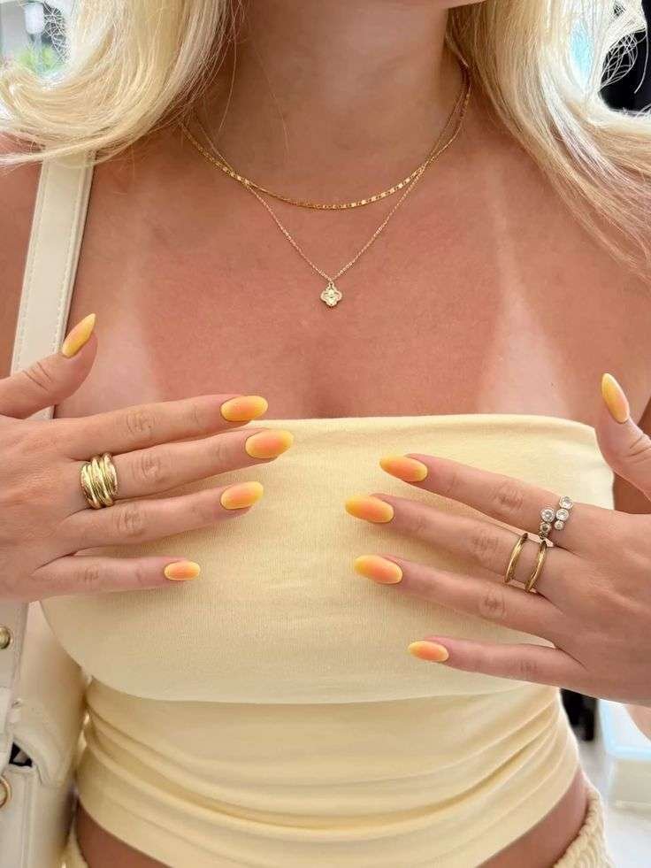 Channel sunshine with lemon-gel yellow nails. Bright lemon, tangerine, and lime are in – Marie Claire notes that citrus yellow is “fashion-forward” and instantly happy. This hue works as a full mani or as accents (like fruit nail art).