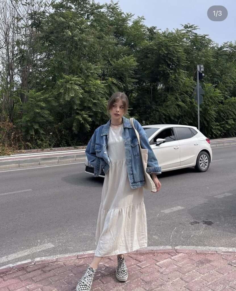 Layering at its finest — perfect for transitional weather. The denim jacket brings casual charm, while the dress keeps it feminine. Complete with ankle boots for a stylish finish.Layering at its finest — perfect for transitional weather. The denim jacket brings casual charm, while the dress keeps it feminine. Complete with ankle boots for a stylish finish.