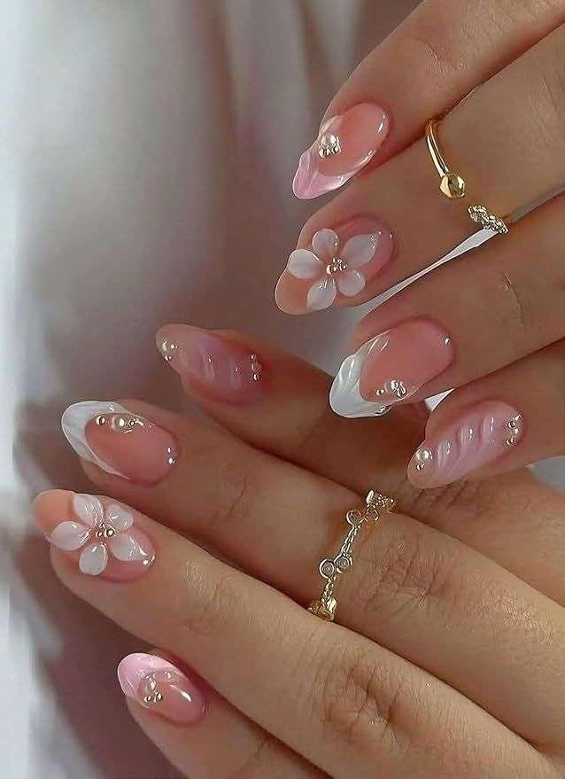 This vibrant nail art style is most commonly referred to as 3D Tropical Shell and Floral nails. The specific design featured in your image is often titled "Summer Wonder" by some nail artists and retailers. 3D Seashells: Textured, raised ridges that mimic the look of real shells, often accented with pearls. Tropical Florals: Hand-painted or 3D flowers, typically hibiscus or other island-inspired blooms in bright pinks, oranges, and yellows. Aura & Gradients: Soft, blended color backgrounds that create a "sunset" or "tropical" glow. Oceanic Accents: Small details like starfish, gold studs, and water droplets (using clear builder gel).