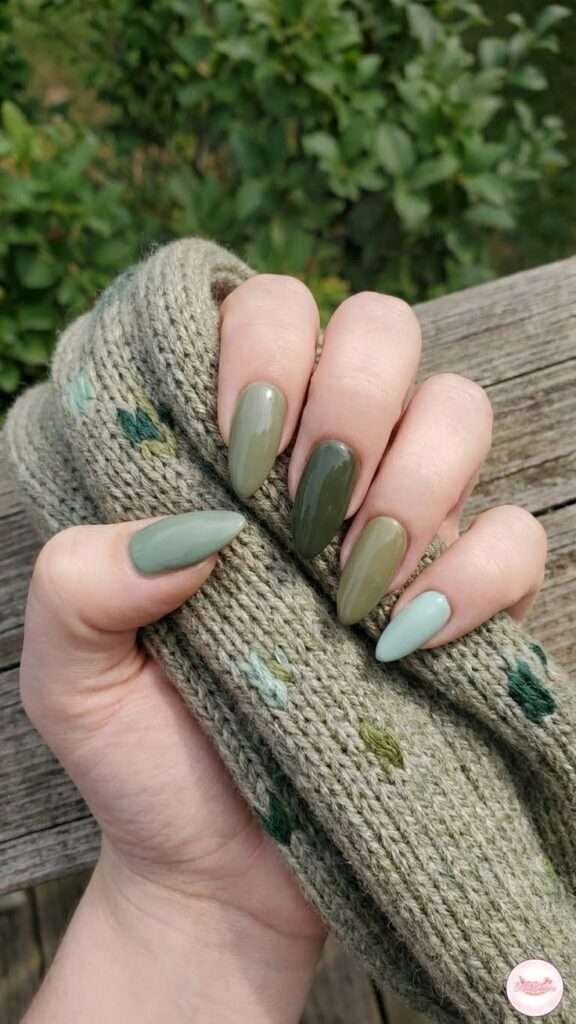 This chic, multi-tonal look is most commonly called Earthy Green Skittle nails or a Mismatched Green Gradient. The "Skittle" name comes from the candy, referring to the trend of painting each nail a different shade within the same color family.