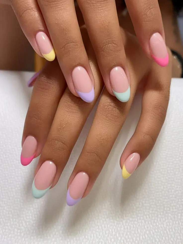 This vibrant and playful look is most commonly referred to as Pastel Rainbow French Tip nails with Floral Accents. n the 2026 nail scene, this specific aesthetic is also called "Skittle French" or "Cottagecore French" because it mixes different colors on each finger with dainty, nature-inspired details.