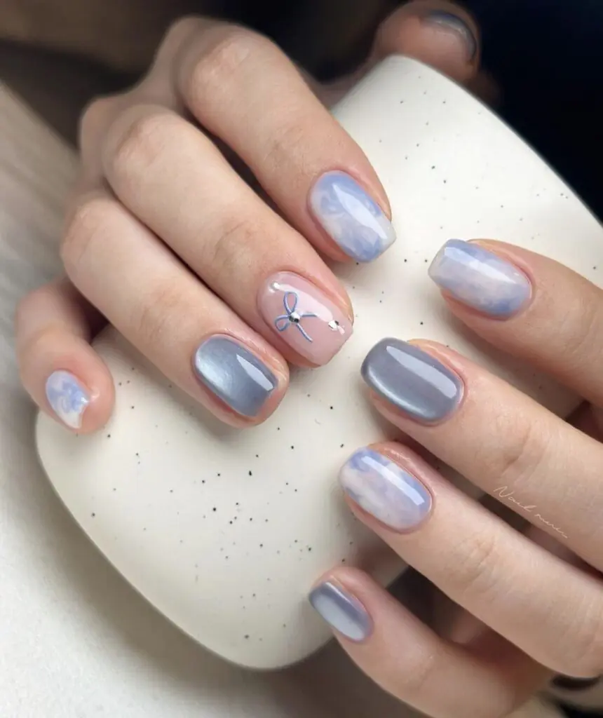 This specific nail art style is most commonly referred to as Pink Velvet Cat Eye nails with Bows. It blends several trendy aesthetics from 2025 and 2026, primarily categorized under the "Coquette" or "Princess" nail trends.