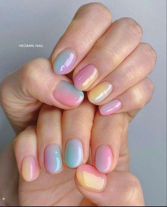 This vibrant and artistic nail style is most commonly referred to as Abstract Watercolor nails or Aura Ink nails. In the 2026 beauty scene, this specific look—featuring soft, bleeding colors on a semi-translucent background—is also being dubbed "Nuance nails". This trend, originating from Japan and Korea, focuses on "gossamer" colors
