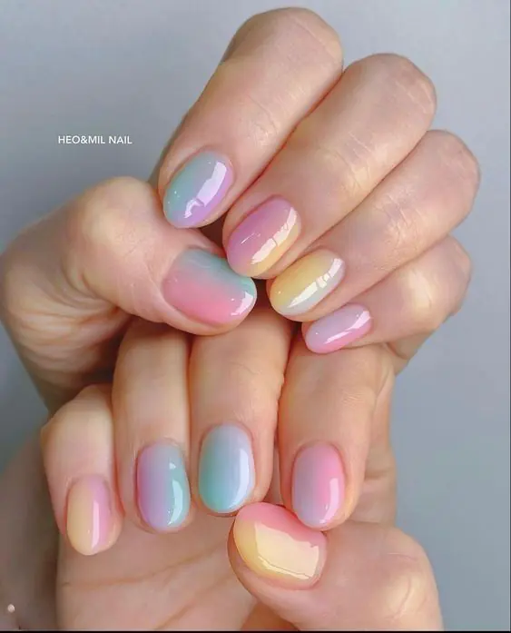 This vibrant and artistic nail style is most commonly referred to as Abstract Watercolor nails or Aura Ink nails. In the 2026 beauty scene, this specific look—featuring soft, bleeding colors on a semi-translucent background—is also being dubbed "Nuance nails". This trend, originating from Japan and Korea, focuses on "gossamer" colors