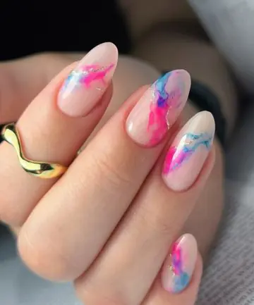This vibrant and artistic nail style is most commonly referred to as Abstract Watercolor nails or Aura Ink nails. In the 2026 beauty scene, this specific look—featuring soft, bleeding colors on a semi-translucent background—is also being dubbed "Nuance nails". This trend, originating from Japan and Korea, focuses on "gossamer" colors