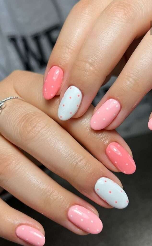 This chic, minimalist look is most commonly referred to as Cherry Polka Dot nails or Minimalist Red-on-Pink dots. In the 2026 nail scene, this specific aesthetic is also a staple of the "Clean Girl" or "Coquette-lite" trends, which emphasize simple, polished patterns on a healthy-looking natural base.
