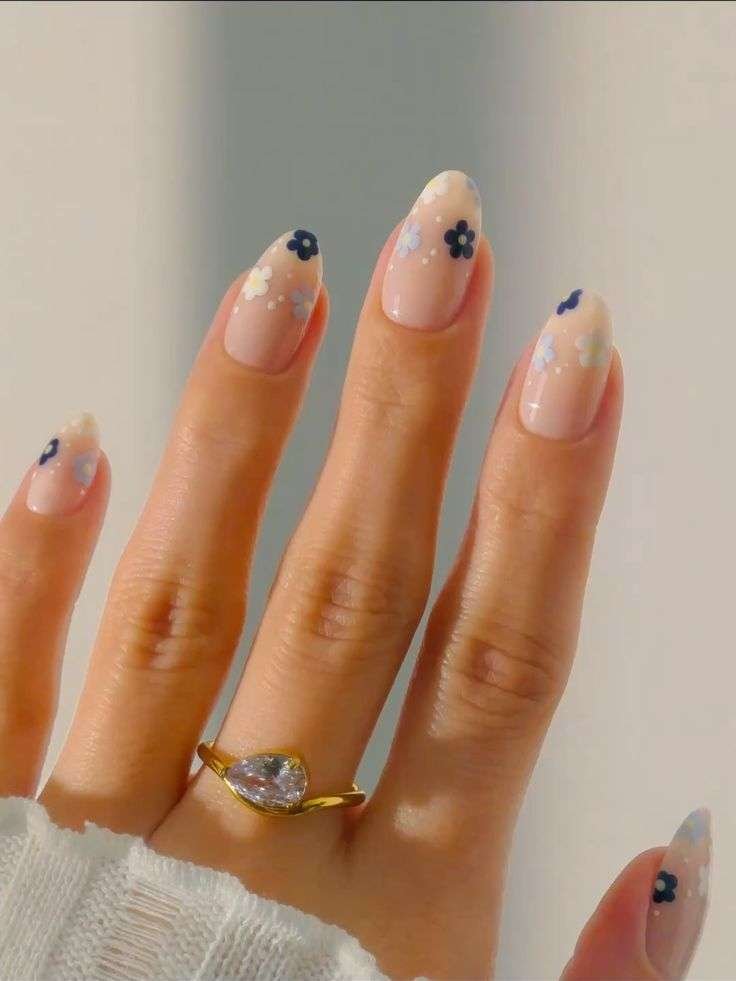 This graceful, clean look is most commonly referred to as Cherry Blossom Minimalist nails or Dainty Floral Almond nails. In the 2026 beauty scene, this specific aesthetic is also categorized under the "Rich Girl" or "Soft Girl" nail trends, which prioritize clean, polished simplicity with subtle, hand-painted details.