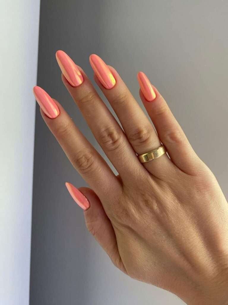 Coral chrome glazed nails are a vibrant, high-shine manicure trend that combines the citrusy warmth of orange with soft pink undertones, finished with a reflective. This style is often referred to as "sunset glazed" or "apricot chrome," offering a modern update to the classic "glazed donut" look popularized by Hailey Bieber