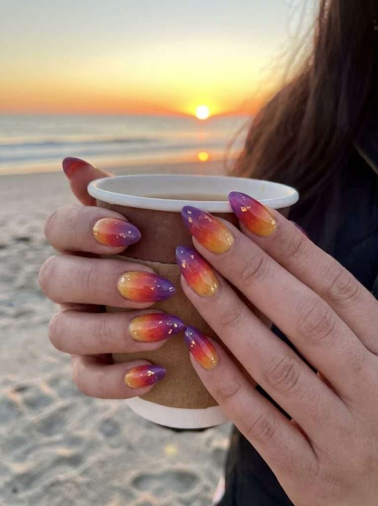 Sunset ombré nails are a vibrant summer trend that captures the warm, glowing hues of the evening sky. This style typically features a seamless gradient of pink, orange, and golden yellow, often accented with silhouettes of palm trees or fine glitter for a "golden hour" effect. In 2026, the trend has shifted toward softer, modern gradients using sheer bases and milky tones for a cleaner, dimensional look. 
