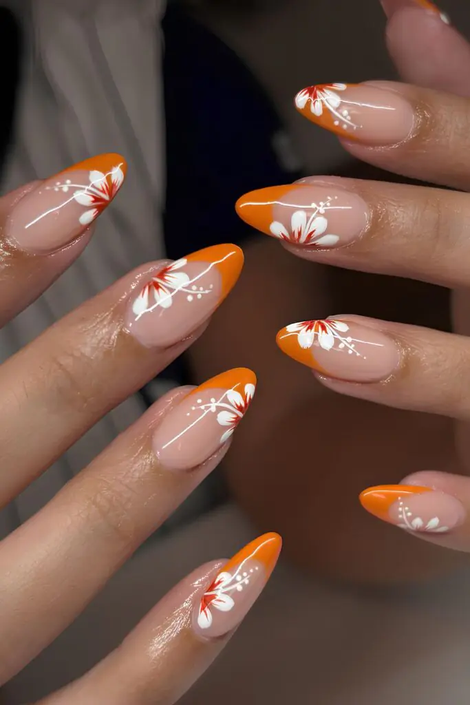 Tropical floral nail art is a vibrant manicure trend that captures the essence of a sun-soaked getaway using exotic motifs like hibiscus flowers, palm leaves, and monstera plants. This aesthetic often features neon or bright tropical colors that pop in direct sunlight, such as fuchsia, tangerine, and turquoise