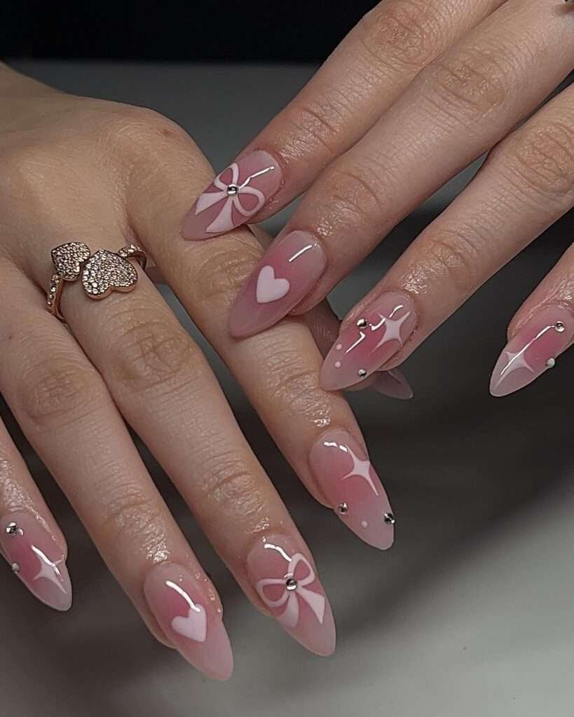 Coquette bow nails are the pinnacle of the "balletcore" and "soft girl" aesthetics, featuring delicate, hyper-feminine details like 3D ribbons, pearls, and lace patterns. This 2026 trend focuses on a "pretty in pink" palette, often utilizing sheer jelly bases to keep the look light and ethereal. 