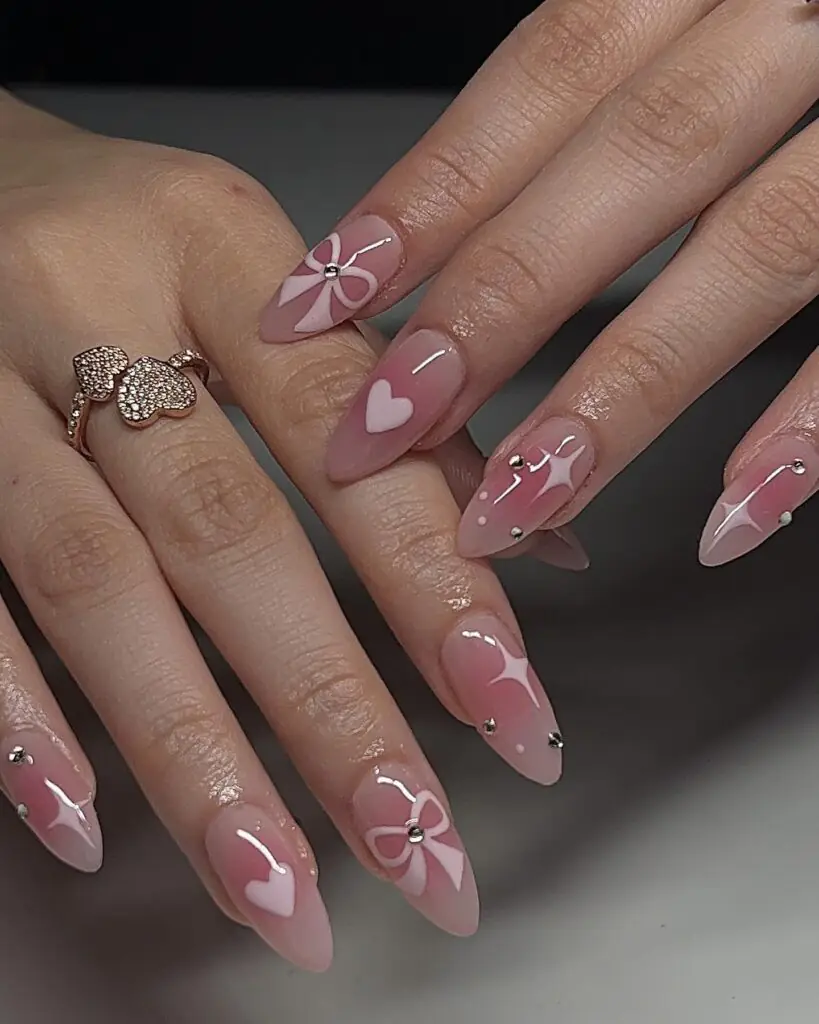 Coquette bow nails are the pinnacle of the "balletcore" and "soft girl" aesthetics, featuring delicate, hyper-feminine details like 3D ribbons, pearls, and lace patterns. This 2026 trend focuses on a "pretty in pink" palette, often utilizing sheer jelly bases to keep the look light and ethereal.