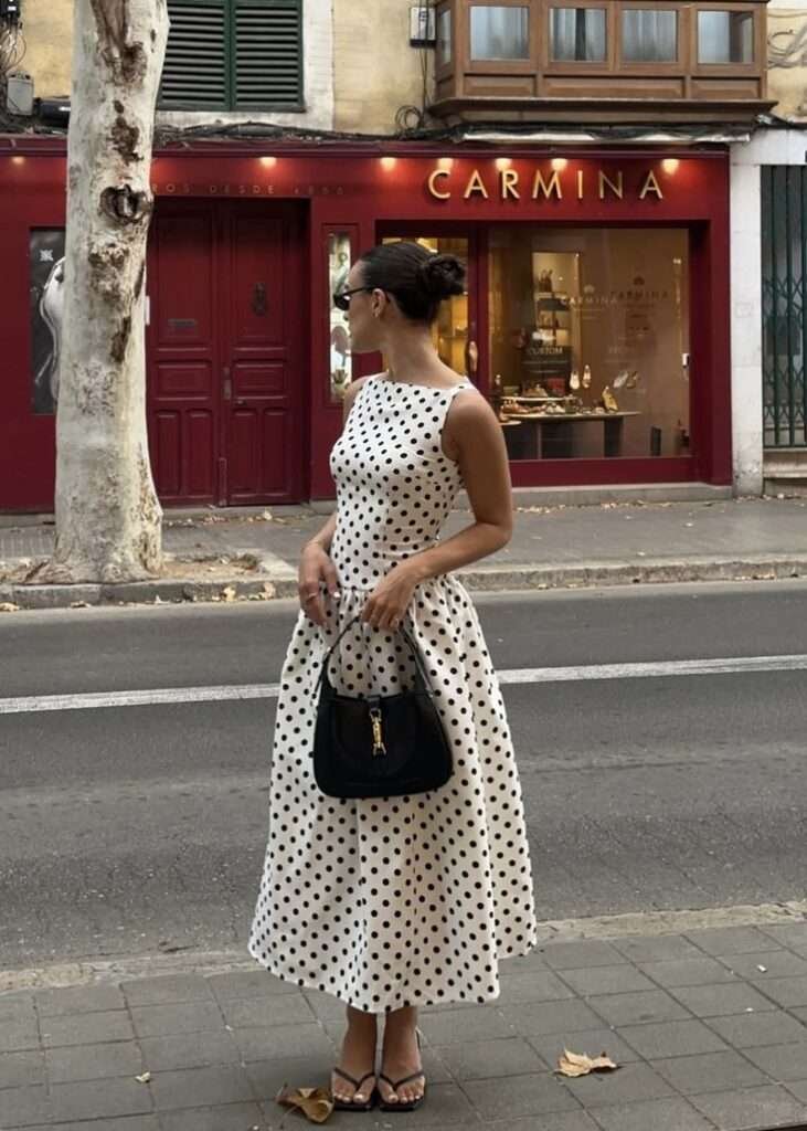 The key to wearing polka dots in Summer 2026 without looking like you raided your grandmother's closet? Scale and restraint. One dotted piece, styled against something architectural or structured. A polka-dot slip skirt with a fitted white tank and kitten mules. A dot-printed blouse worn open over a bikini top for the beach. That's the energy.