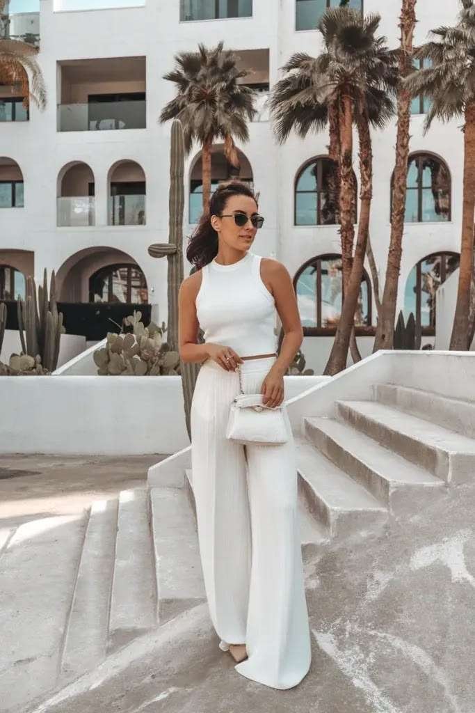 The "clean girl aesthetic" is still huge in 2026, and an all-white summer outfit is its crown jewel. A crisp white fitted tank tucked into flowy white wide-leg linen pants looks incredibly chic. 