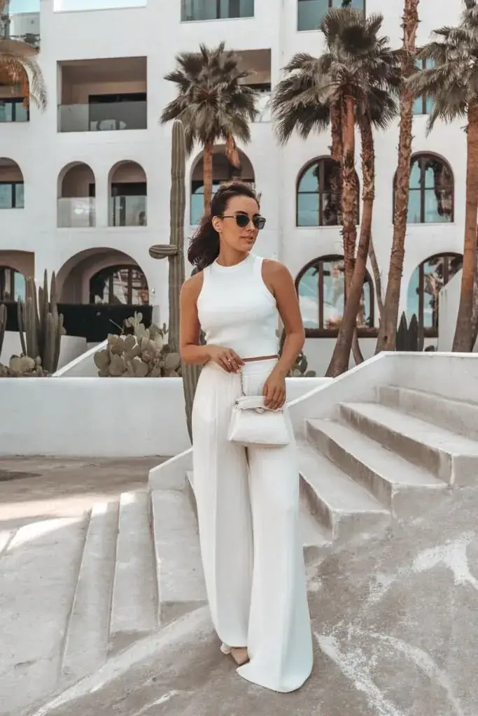 The "clean girl aesthetic" is still huge in 2026, and an all-white summer outfit is its crown jewel. A crisp white fitted tank tucked into flowy white wide-leg linen pants looks incredibly chic. 
