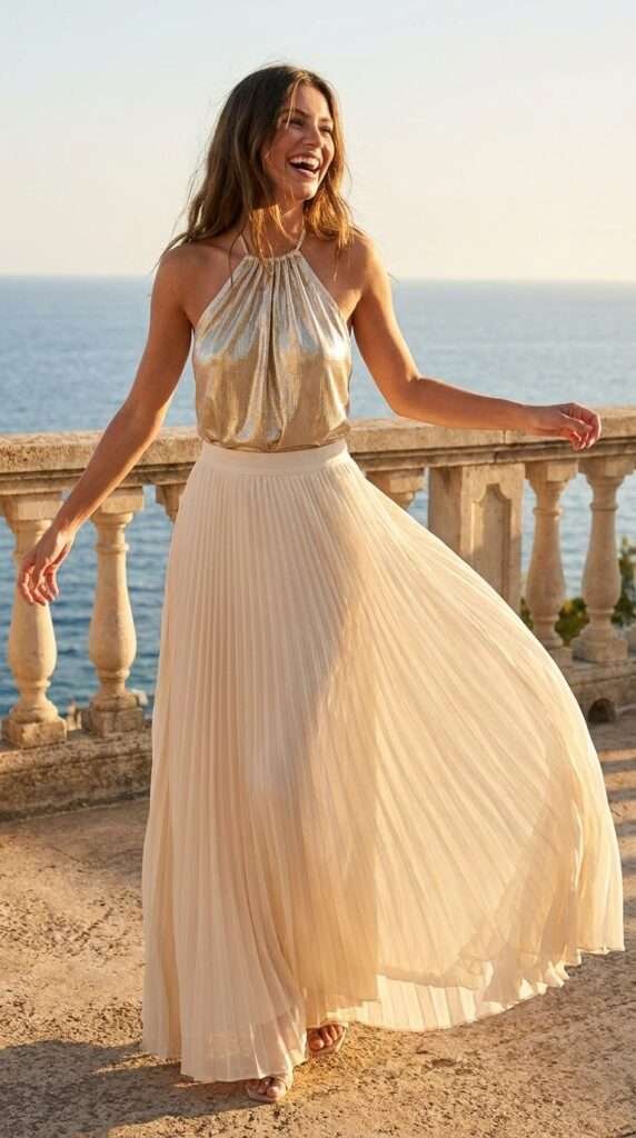 For the girls who love a little shimmer, a metallic gold halter top is this summer's biggest night-out piece. They look incredible paired with a flowy cream or ivory midi skirt, gold strappy heels, and statement earrings.