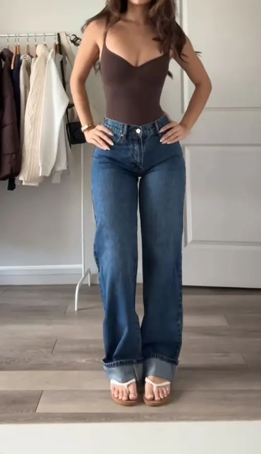 Wear your one-piece swimsuit as a bodysuit tucked into high-waist jeans. It's one of the most brilliant casual summer outfit ideas because it works for daytime adventures and can transition to an evening look easily. Toss on a linen overshirt, white sneakers, and a baseball cap, and you're good to go from the pier to the patio.