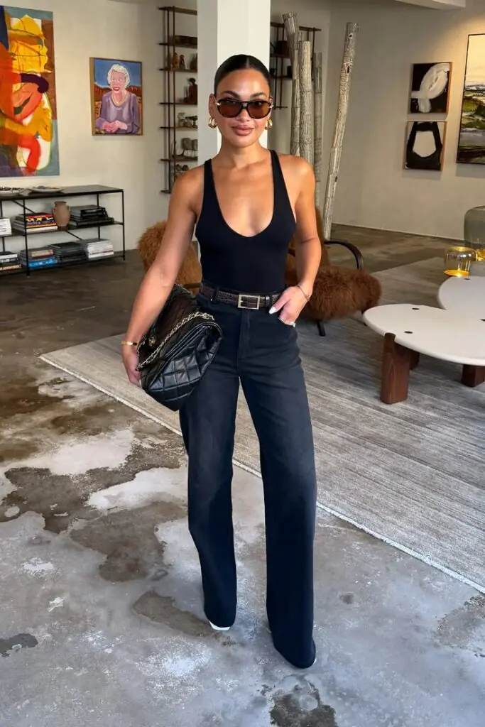 Wear your one-piece swimsuit as a bodysuit tucked into high-waist jeans. It's one of the most brilliant casual summer outfit ideas because it works for daytime adventures and can transition to an evening look easily. Toss on a linen overshirt, white sneakers, and a baseball cap, and you're good to go from the pier to the patio.