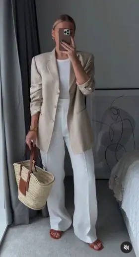 For those who love a clean, elevated aesthetic, the neutral power suit is the summer 2026 uniform of choice. Beige straight-leg trousers with an oversized white linen blazer (sleeves pushed up casually) is everything you need for summer work days, outdoor events, and smart casual dinners. Pair with cream loafers and a sleek black bag to complete the look.