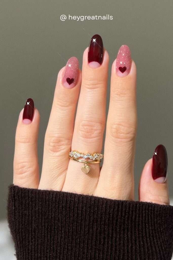 Tiny dark red hearts on a sparkling pink glitter base, combined with deep oxblood solid nails — this is the perfect fall nail art for a date night or holiday event in 2026.