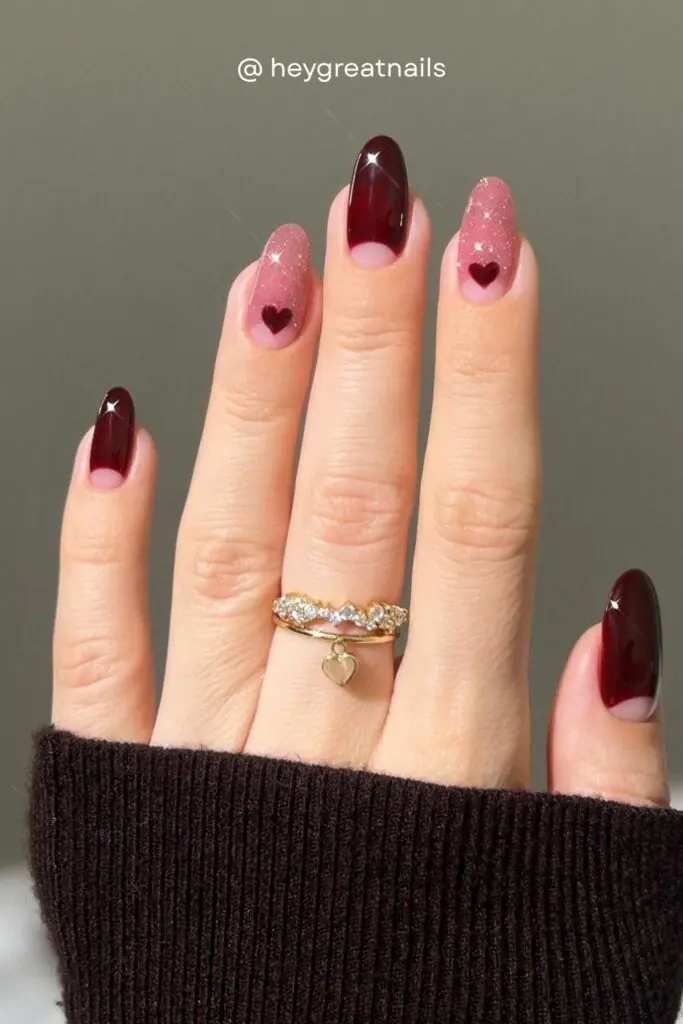 Tiny dark red hearts on a sparkling pink glitter base, combined with deep oxblood solid nails — this is the perfect fall nail art for a date night or holiday event in 2026.