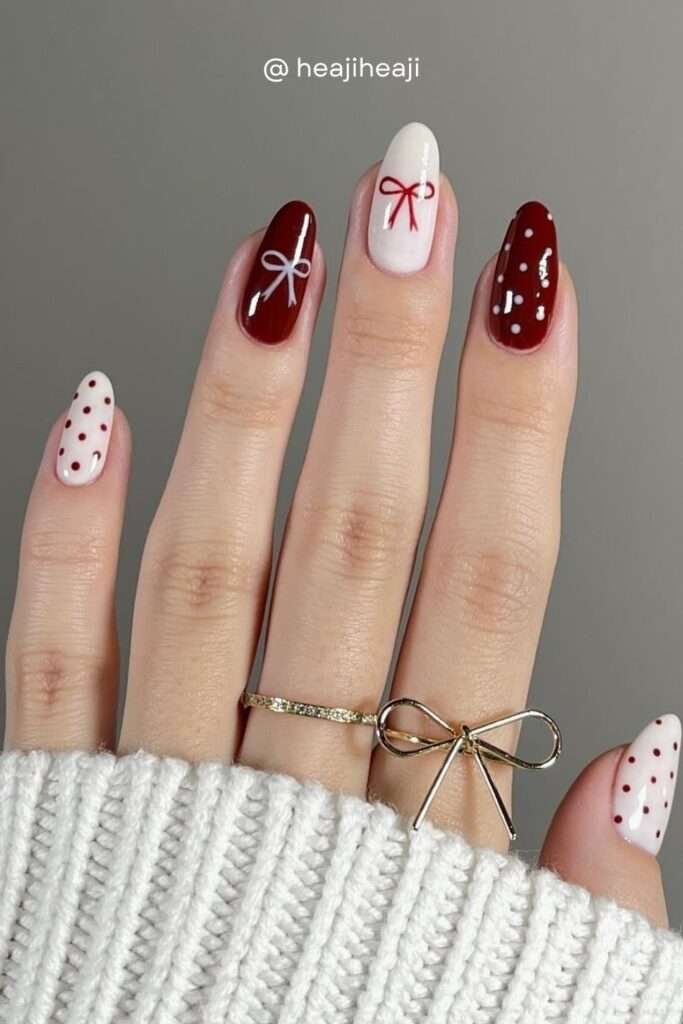 The bow nail trend isn't going anywhere for fall 2026. Dark red bows on a creamy white base, paired with red polka dot nails, creates the most delightfully coquette autumn manicure.
