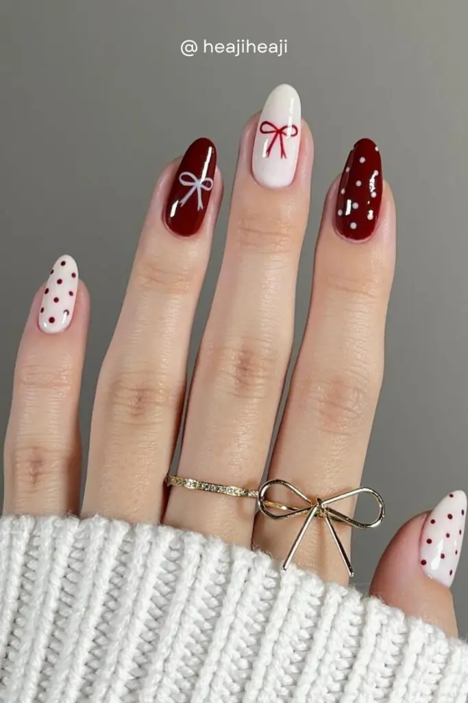 The bow nail trend isn't going anywhere for fall 2026. Dark red bows on a creamy white base, paired with red polka dot nails, creates the most delightfully coquette autumn manicure.