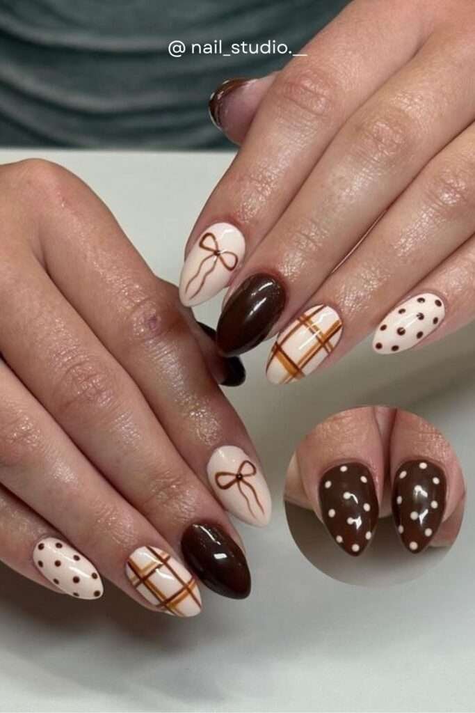 A complete fall nail story in one set — plaid art nail, bow art nail, solid chocolate brown, and polka dot. The ultimate cozy fall nail combo for 2026.