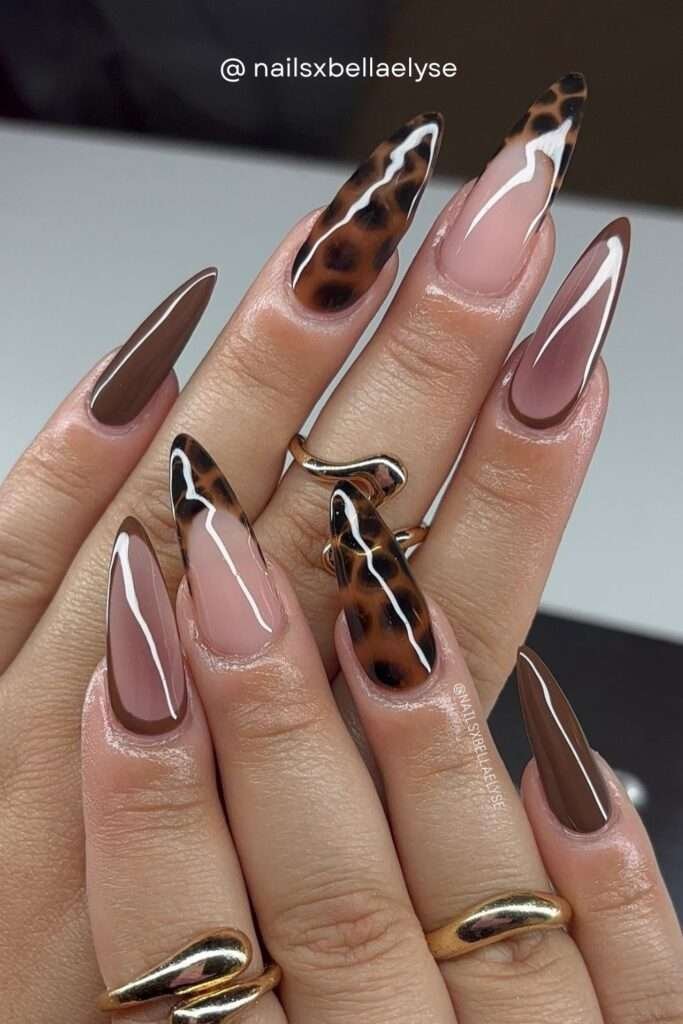 If you want heads turning everywhere, tortoiseshell nail art is your fall 2026 statement look. Combining warm brown, black, amber, and white in swirling abstract patterns, this style is bold, fashion-forward, and impossible to ignore.
