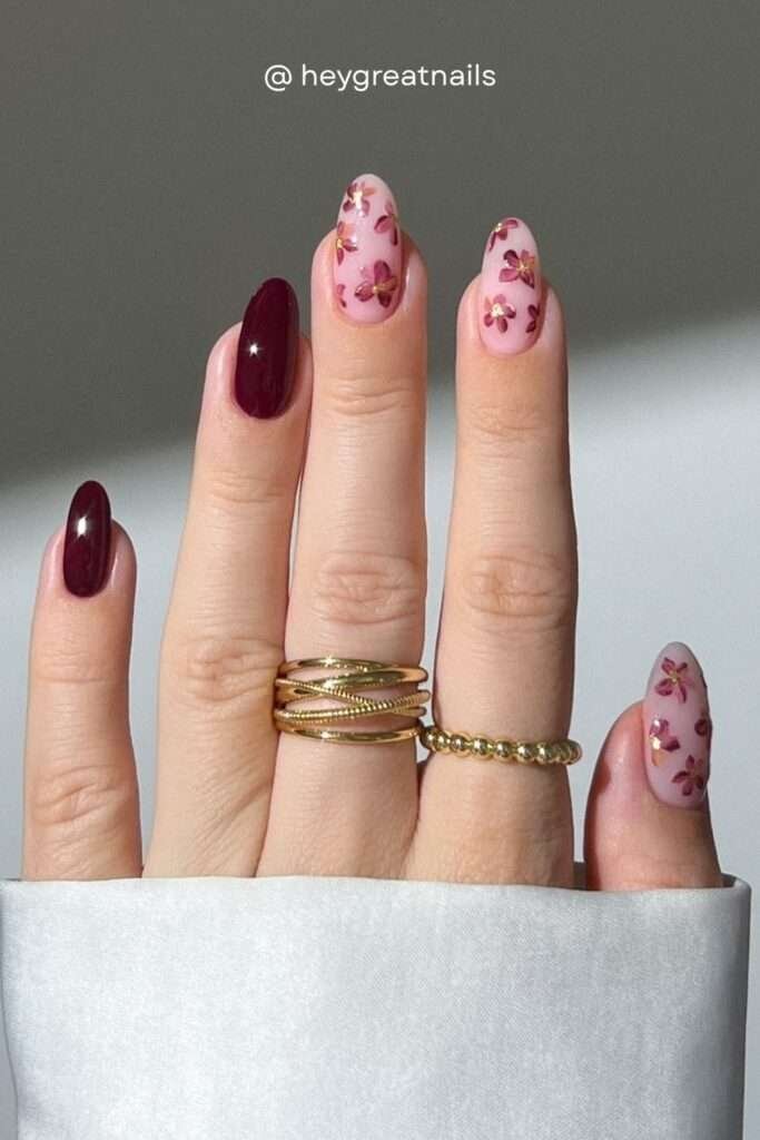 Dark floral nails are everywhere this autumn. Burgundy and dusty rose flowers on a pale pink base create a look that's delicate but moody — deeply fall and undeniably feminine.