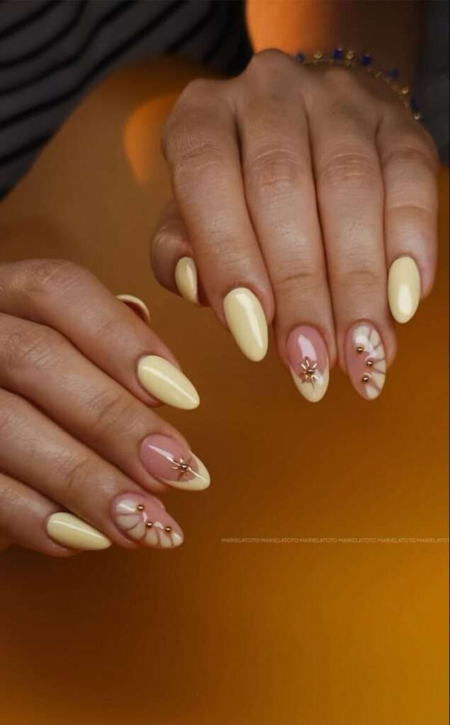 This ultra-chic design pairs a creamy, soft yellow palette with intricate gold celestial hardware for an undeniably celestial summer vibe. The mix of buttery solid shades, negative space framing, and raised metallic stars delivers an immediate high-end jewelry effect on the fingertips. It is a masterfully curated look that feels both warm and deeply luxurious, making it the perfect choice for an upscale mid-summer aesthetic.