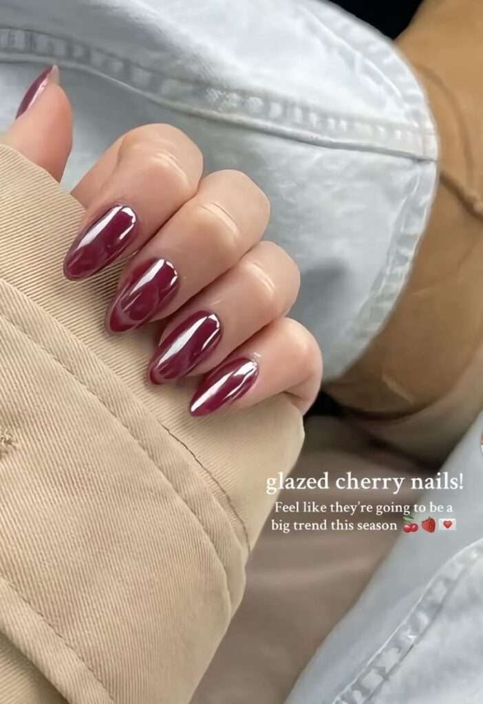 This look delivers a striking fusion of deep berry tones and a high-shine chrome overlay that instantly screams high-end luxury. The luminous, reflective finish transforms a classic dark red manicure into a modern, multi-dimensional statement piece perfect for warm July nights. It is the ultimate choice for anyone wanting a bold, sultry aesthetic that looks like it cost a fortune at a boutique salon.
