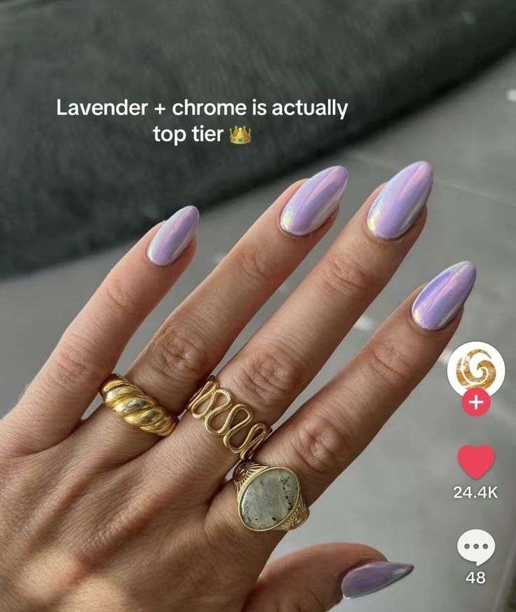 The perfectly sculpted almond nails catch the July sunlight from every angle, reflecting subtle pink and icy blue undertones. It offers a fresh, clean-girl alternative to basic neutrals while maintaining an elite finish that feels incredibly curated and fashion-forward. This captivating look redefines summer pastels by layering an iridescent glaze over a dreamy lavender base for a futuristic, pearlescent glow.