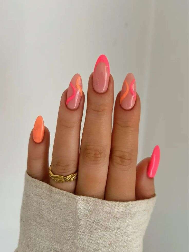 Inject high-energy luxury into your summer curation with this striking mix of neon pink French tips, solid coral accents, and fluid, multi-toned swirl art. The flawless almond shaping keeps the electric color palette feeling grounded and sophisticated, proving that vibrant neons can look incredibly chic when executed with precision. It is the ultimate poolside statement set for July, offering an upscale twist on classic festival-season aesthetics.