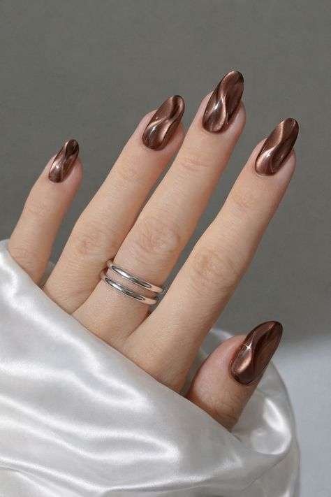 Chocolate brown nails are pretty much the unofficial color of fall every single year, and 2026 is no exception. This shade works on almost every skin tone, from fair to deep, and pairs beautifully with gold jewelry, camel coats, and cozy knitwear.