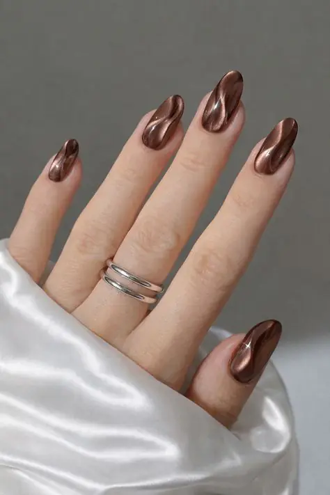 Chocolate brown nails are pretty much the unofficial color of fall every single year, and 2026 is no exception. This shade works on almost every skin tone, from fair to deep, and pairs beautifully with gold jewelry, camel coats, and cozy knitwear.