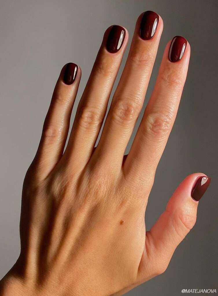 Deep burgundy is the kind of color that instantly makes your hands look more put together. It has just enough red undertone to feel festive without veering into full holiday territory too early in the season.