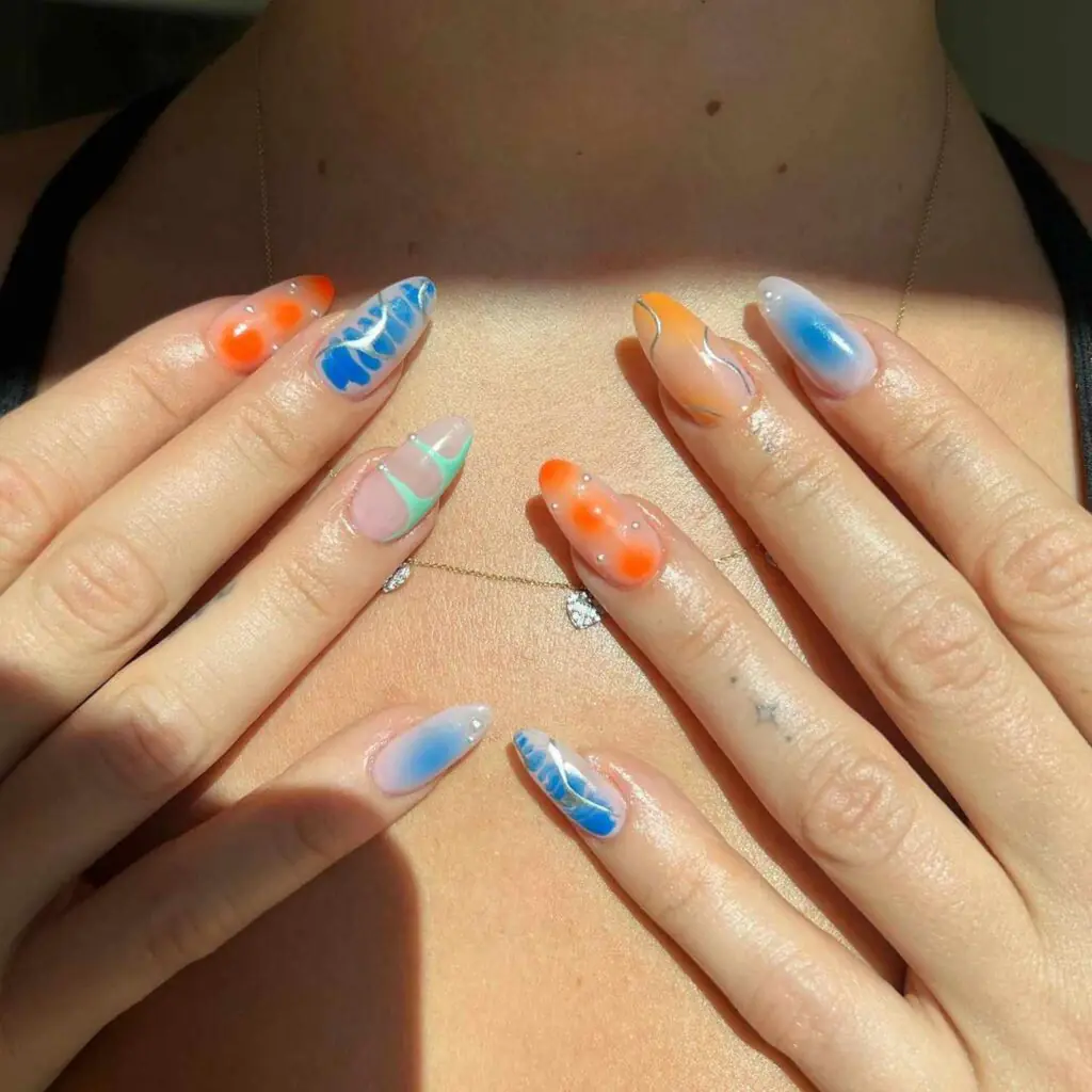 Sunset Aura Mix August Nails. Make a bold statement with "Sunset Aura Mix," an eclectic nail art design redefining late summer beauty trends.