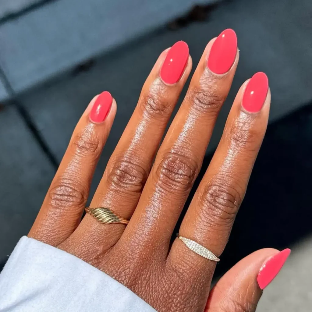 August 2026 coral pink almond nails with glossy finish for late summer nail trends
