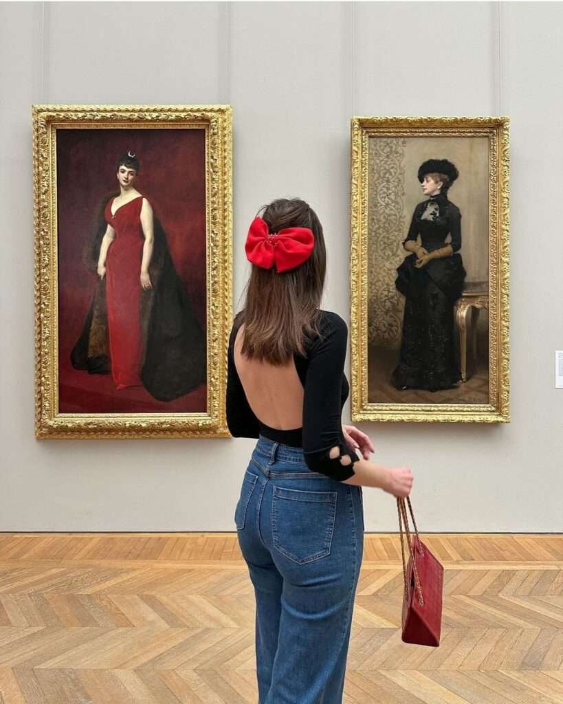 Elegant half-up hairstyle with a red satin bow, the ultimate backless-top hairstyle for evening and gallery outfits.