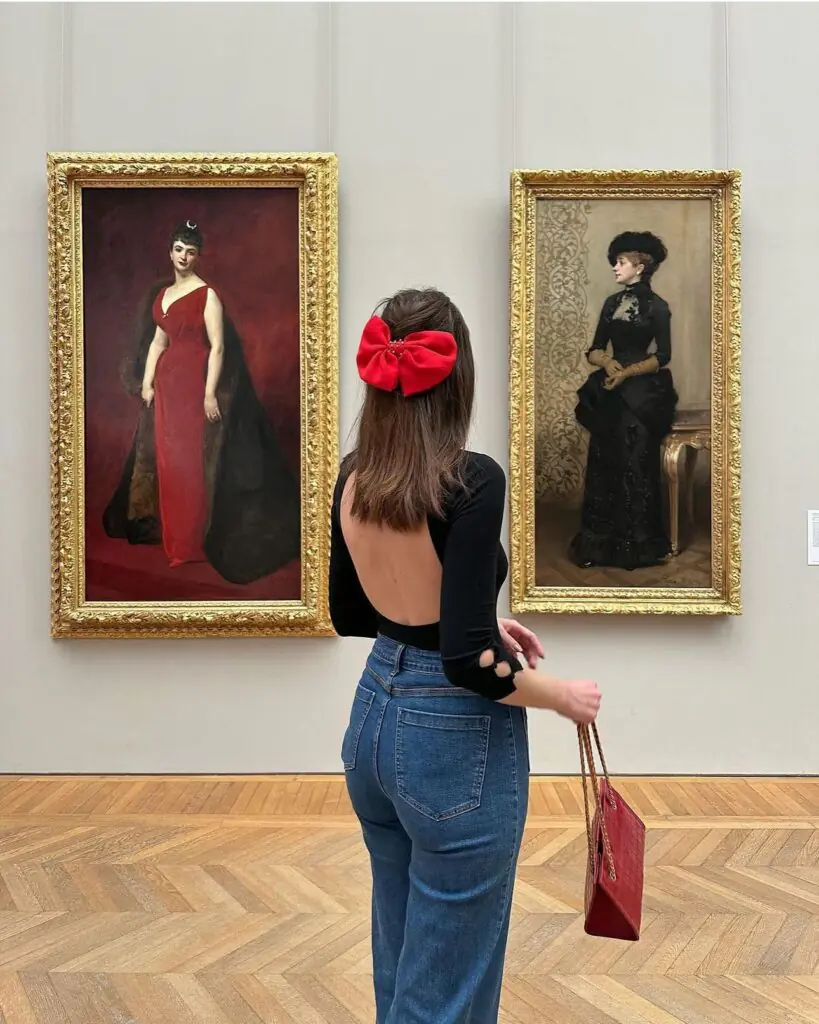 Elegant half-up hairstyle with a red satin bow, the ultimate backless-top hairstyle for evening and gallery outfits.
