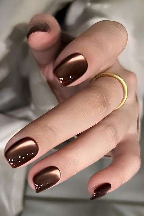 Chocolate brown nails are pretty much the unofficial color of fall every single year, and 2026 is no exception. This shade works on almost every skin tone, from fair to deep, and pairs beautifully with gold jewelry, camel coats, and cozy knitwear.