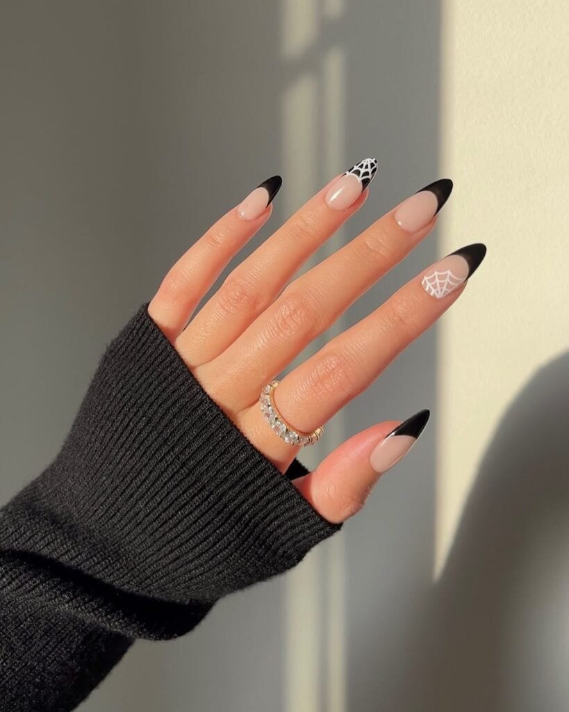 Black French Spider Web Halloween Nails. Minimalist Halloween nails continue to dominate trend forecasts, and this black French tip manicure proves why.
