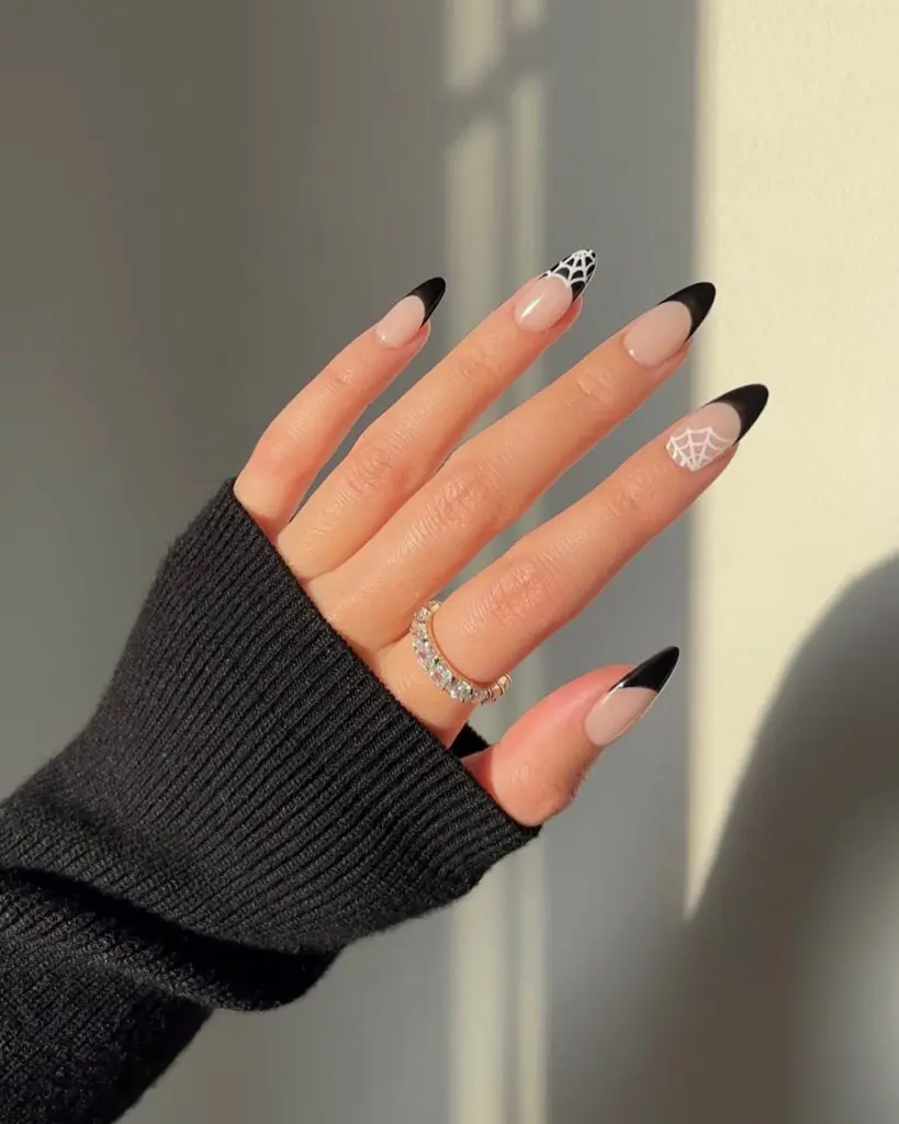 Black French Spider Web Halloween Nails. Minimalist Halloween nails continue to dominate trend forecasts, and this black French tip manicure proves why.