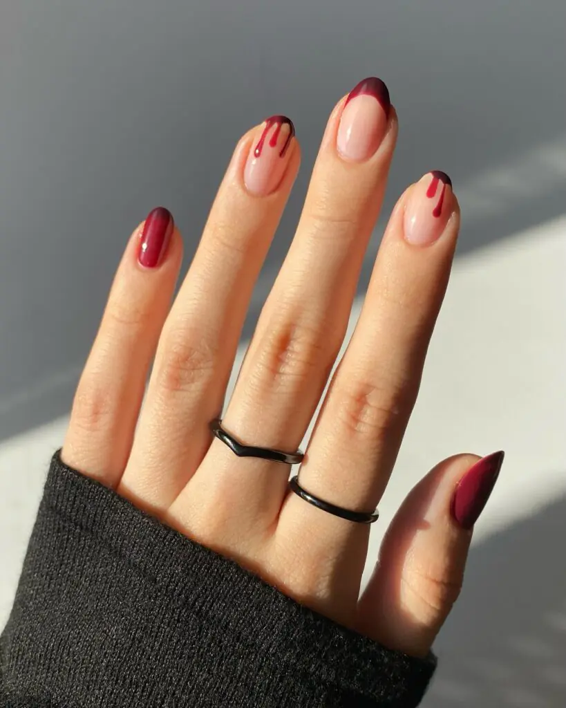Blood Drip French Tips Halloween nail ideas 2026. This hauntingly chic Halloween manicure combines a sheer nude base with deep oxblood French tips and realistic blood-drip accents.