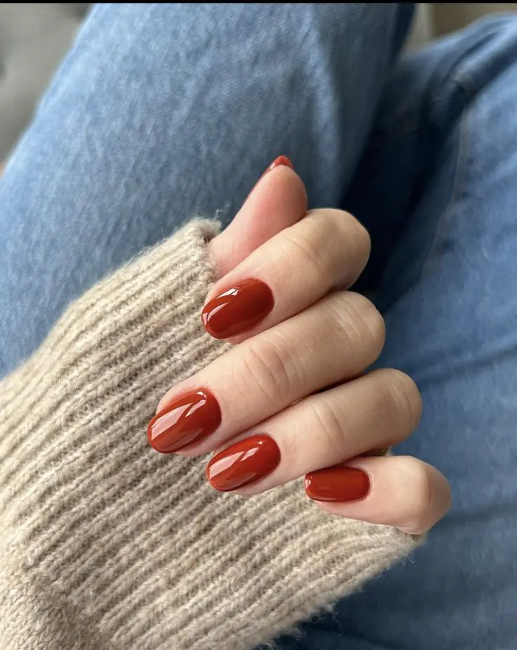 Rust red is bolder than terracotta and warmer than burgundy, landing in this perfect in-between zone that feels distinctly autumn. It's an easy way to add color to your manicure without straying from a fall-appropriate palette, and it looks incredible against tan or olive skin tones especially.