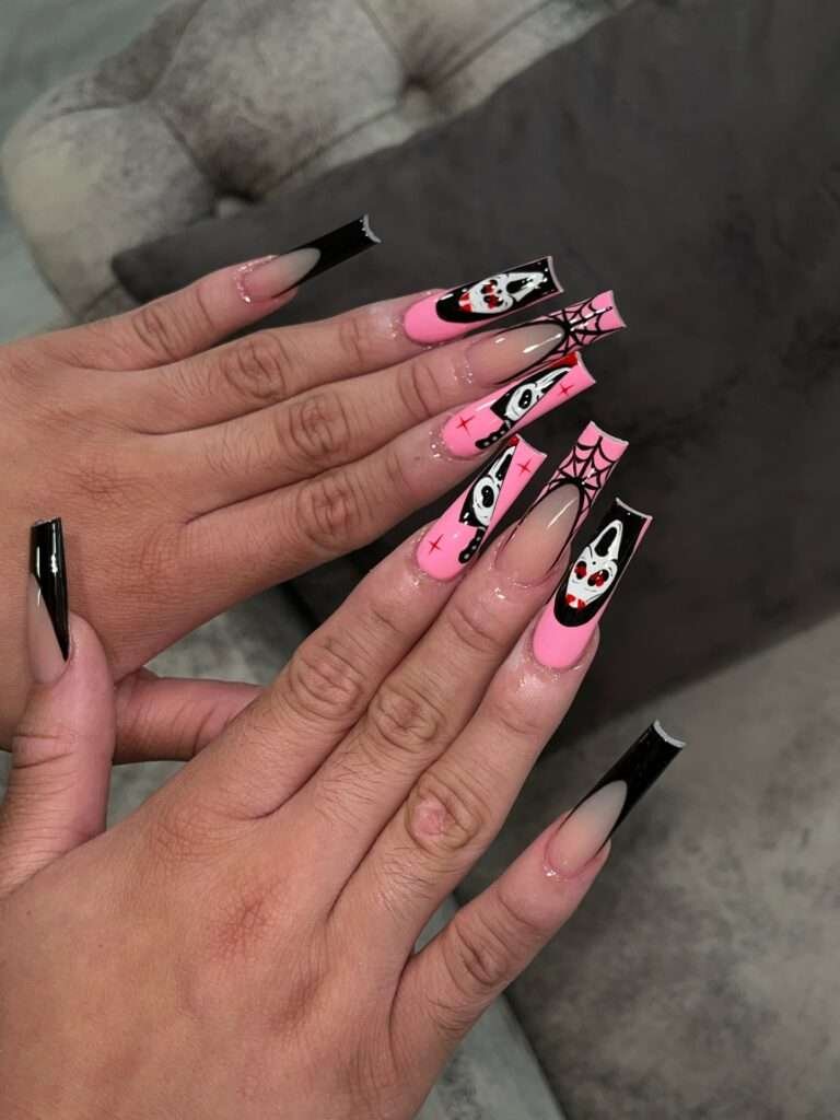 Some October manicures are meant to make you smile every time you reach for your coffee. This pink-and-black set mixes playing-card faces, spiderwebs, sharp French tips, and tiny graphic marks for a look that feels like a Halloween party in miniature. I would choose it for a costume, a concert, or simply because a little extra joy belongs on your hands too.
