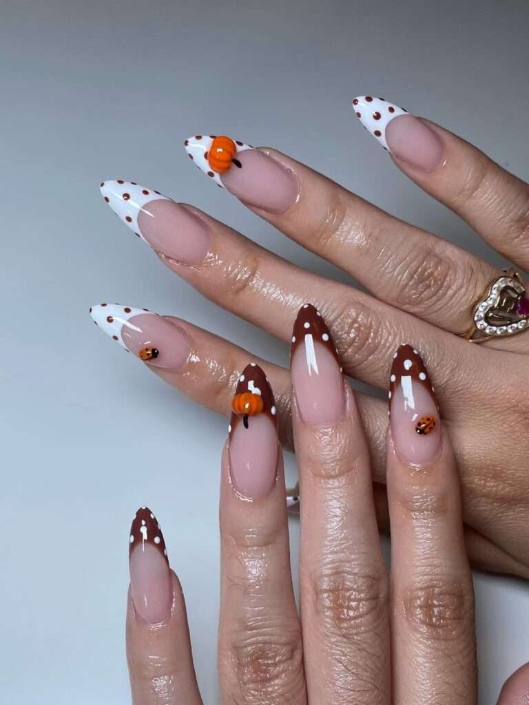 For a softer Halloween manicure, use a milky base with delicate black-and-white details and little pops of orange. The result is cute rather than frightening, and it works beautifully on almond or stiletto extensions. I love this idea for anyone who wants seasonal nails but still reaches for cream sweaters, blush makeup, and warm neutrals the rest of the month.